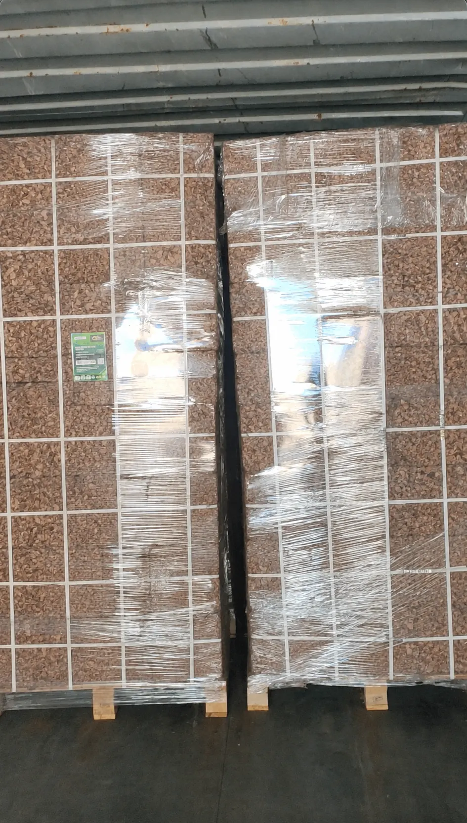 Two wrapped pallets of coco husk chips blocks positioned inside a container